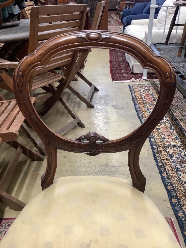 A set of six Victorian carved walnut balloon back dining chairs